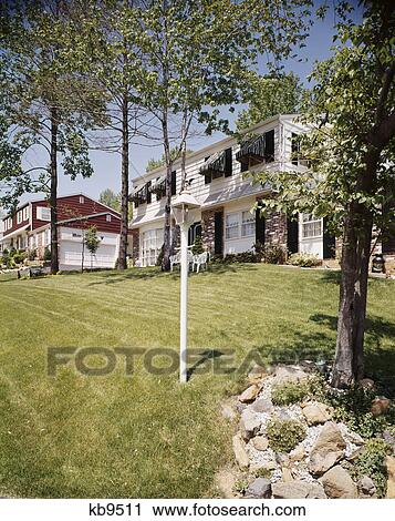 1970s two houses landscaped lawns awnings on windows suburban neighborhood residential community View Large Photo Image Stock Image - 1970s two houses landscaped lawns awnings on windows suburban neighborhood residential community. Fotosearch