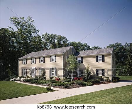 1970s two story colonial tan house with black shutters landscaped lawn View Large Photo Image Stock Image - 1970s two story colonial tan house with black shutters landscaped lawn. Fotosearch