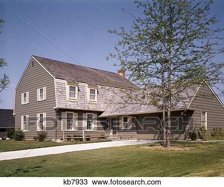 1970s two story grey house with cream shutters garage landscaped lawn suburban residential View Large Photo Image Stock Image - 1970s two story grey house with cream shutters garage landscaped lawn suburban residential. Fotosearch