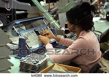 Stock Photo - 1970s woman assembling computer. Fotosearch