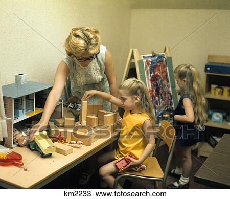 1970s woman doctor observing children playing and drawing View Large Photo Image Stock Image - 1970s woman doctor observing children playing and drawing. Fotosearch