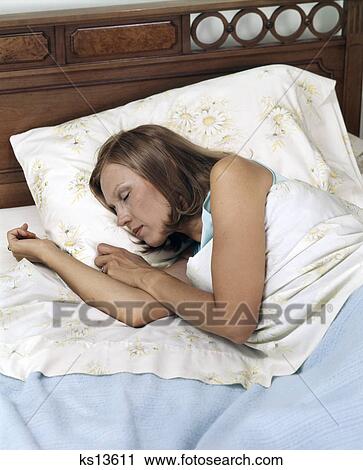 1970s woman in bed sleeping blue blanket View Large Photo Image Stock Image - 1970s woman in bed sleeping blue blanket. Fotosearch