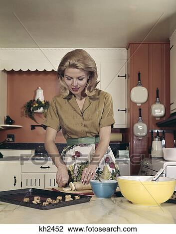 1970s woman kitchen baking cookies apron mixing bowl View Large Photo Image Stock Image - 1970s woman kitchen baking cookies apron mixing bowl. Fotosearch
