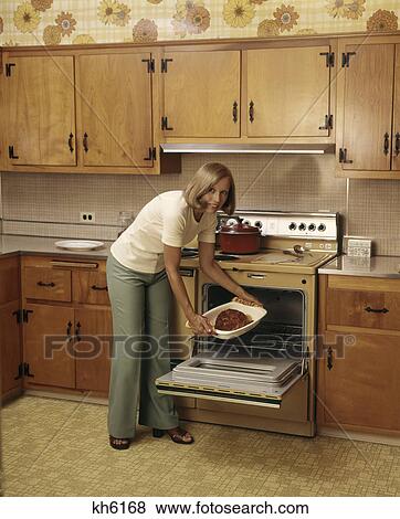 1970s woman kitchen cooking oven ham View Large Photo Image Stock Photo - 1970s woman kitchen cooking oven ham. Fotosearch