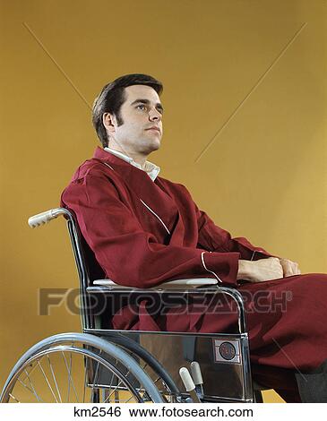 1970s young man sitting in wheelchair serious expression View Large Photo Image Stock Photograph - 1970s young man sitting in wheelchair serious expression. Fotosearch