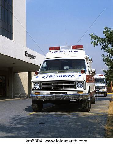 Picture - 1980s ambulance at hospital emergency entrance. Fotosearch