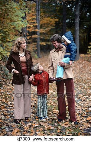 1980s family mother father children walking in autumn woods View Large Photo Image Stock Image - 1980s family mother father children walking in autumn woods. Fotosearch