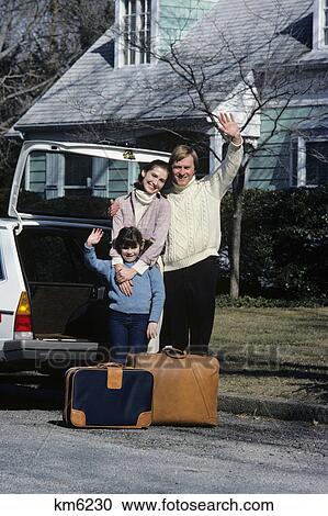 1980s family mother father son waving goodbye loading luggage into car View Large Photo Image Stock Image - 1980s family mother father son waving goodbye loading luggage into car. Fotosearch