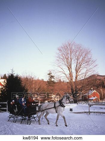1980s family riding through snow in horse drawn sleigh View Large Photo Image Picture - 1980s family riding through snow in horse drawn sleigh. Fotosearch