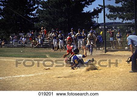 1980s little league baseball game player sliding into home base View Large Photo Image Stock Image - 1980s little league baseball game player sliding into home base. Fotosearch