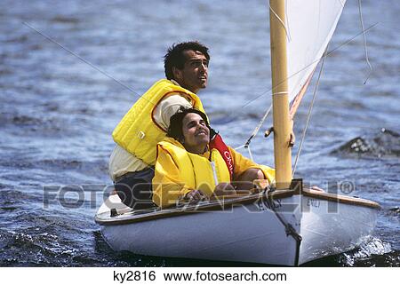 1980s man and woman crew sailing a melon seed skiff on river View Large Photo Image Stock Photograph - 1980s man and woman crew sailing a melon seed skiff on river. Fotosearch