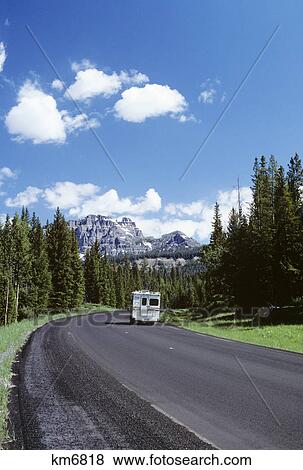 Stock Photo - 1980s motor camper on road in wyoming. Fotosearch