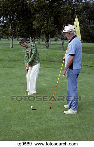 1980s senior man & woman playing golf View Large Photo Image Stock Photo - 1980s senior man & woman playing golf. Fotosearch