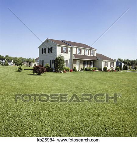 1980s suburban two story house with large front lawn and shrubbery View Large Photo Image Picture - 1980s suburban two story house with large front lawn and shrubbery. Fotosearch