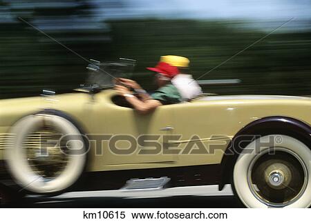 1990s couple riding in antique convertible car View Large Photo Image Stock Photography - 1990s couple riding in antique convertible car. Fotosearch