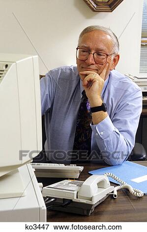 1990s older man working at home computer View Large Photo Image Stock Photo - 1990s older man working at home computer. Fotosearch