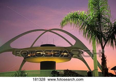 Stock Photo - 1990s palm tree and arches of the futuristic theme building and restaurant at los angeles airport california. Fotosearch