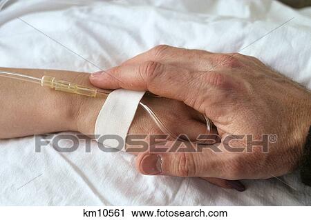 adult hand holding child's hand on hospital bed View Large Photo Image Stock Image - adult hand holding child's hand on hospital bed. Fotosearch