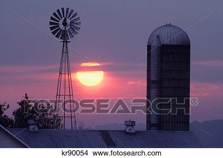 Picture - amish farm at sunrise with windmills and silo, lancaster county pennsylvania. Fotosearch