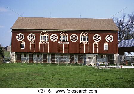 Stock Image - barn with hex signs over doors and windows. Fotosearch