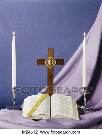 bible open to book of isaiah cross and candles on purple background View Large Photo Image Stock Image - bible open to book of isaiah cross and candles on purple background. Fotosearch