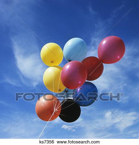 bunch of multi colored balloons against a blue sky View Large Photo Image Stock Photograph - bunch of multi colored balloons against a blue sky. Fotosearch