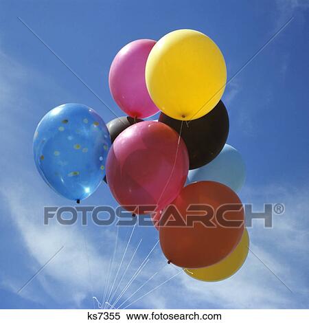 bunch of multi colored balloons against a blue sky View Large Photo Image Stock Photography - bunch of multi colored balloons against a blue sky. Fotosearch