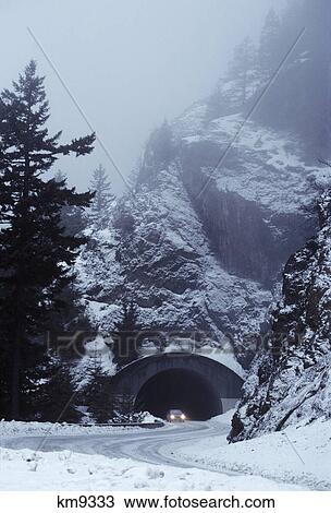 car with lights on exiting mountain highway tunnel in winter View Large Photo Image Stock Image - car with lights on exiting mountain highway tunnel in winter. Fotosearch