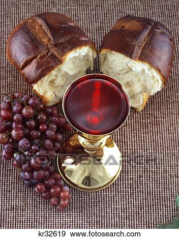chalice full of wine grapes and bread communion still life View Large Photo Image Stock Photo - chalice full of wine grapes and bread communion still life. Fotosearch