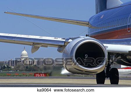 Picture - close up of airplane capitol building in distance washington, dc. Fotosearch