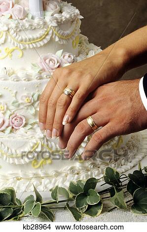 Picture - close up of wedding rings on hands. Fotosearch