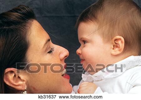 close up profile portrait of mother holding baby View Large Photo Image Stock Photo - close up profile portrait of mother holding baby. Fotosearch