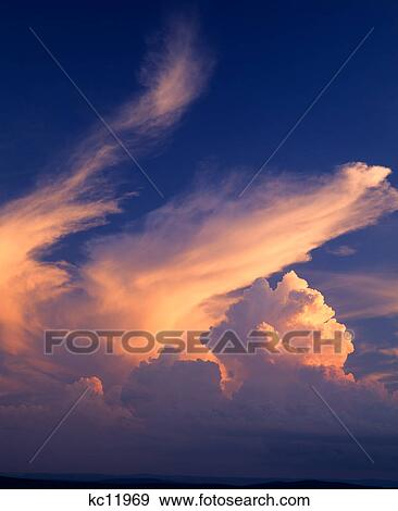 Stock Photo - clouds reflecting sunset glow. Fotosearch