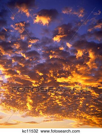 clouds with golden sun glow in blue sky View Large Photo Image Stock Image - clouds with golden sun glow in blue sky. Fotosearch