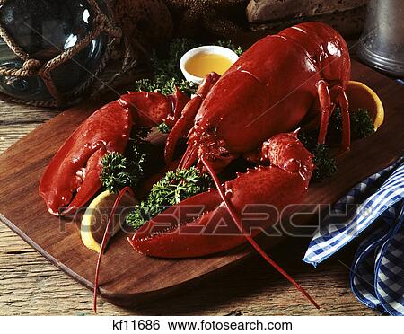 cooked lobster on wooden platter with lemon wedge and drawn butter View Large Photo Image Stock Photograph - cooked lobster on wooden platter with lemon wedge and drawn butter. Fotosearch