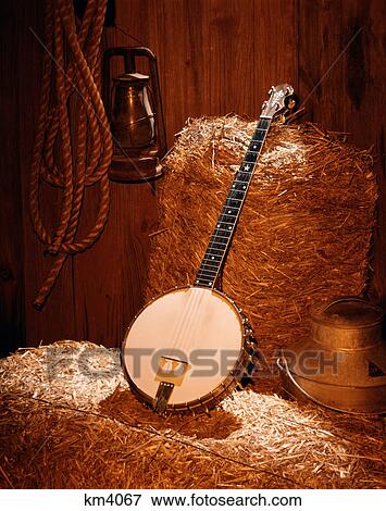 country music still life of banjo on bales of hay in barn View Large Photo Image Stock Photo - country music still life of banjo on bales of hay in barn. Fotosearch