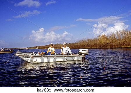 Stock Photography - couple in boat fishing kissimmee river florida. Fotosearch