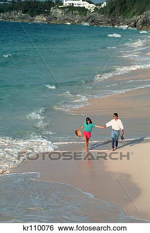 Stock Photograph - couple walking on beach bermuda. Fotosearch