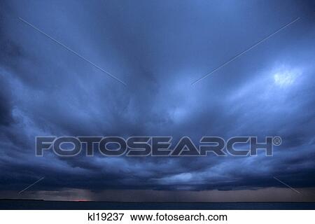 dark blue thunder storm clouds at sunset View Large Photo Image Stock Photo - dark blue thunder storm clouds at sunset. Fotosearch