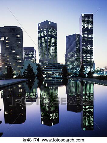 Picture - downtown los angeles skyline at twilight skyscrapers reflected in water. Fotosearch
