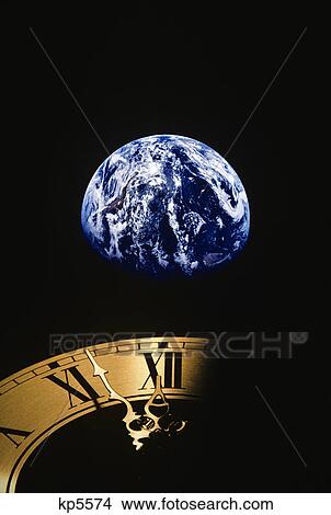 Picture - earth and clock face at 11: 57. Fotosearch