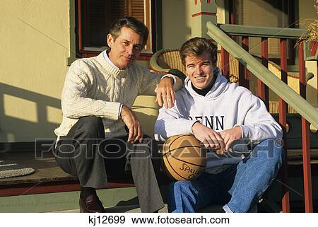 Stock Photo - father and college age son on porch steps. Fotosearch