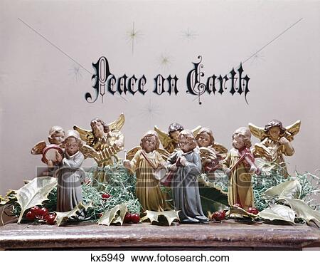 Stock Photo - figurines christmas angels playing musical instruments under words peace on earth. Fotosearch