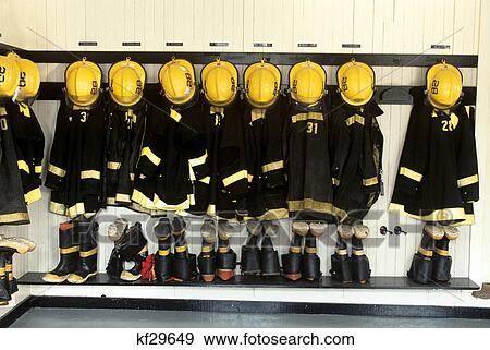 Stock Photo - firefighter gear hanging in firehouse. Fotosearch