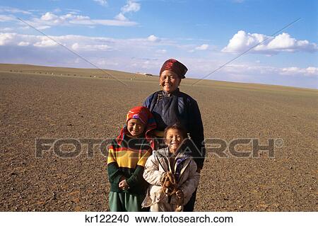 Stock Image - gobi desert, mongolia smiling mother and two daughters. Fotosearch