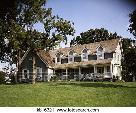 Gray Two Story House With Front Porch Four Dormer Style Windows
