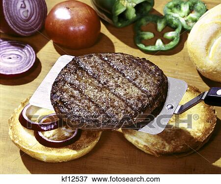 Stock Photo - hamburger beef patty, onion, tomatoes & peppers and rolls. Fotosearch