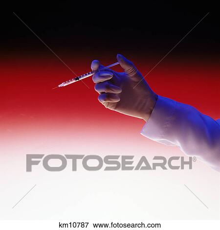 Stock Photo - hand holding a needle. Fotosearch