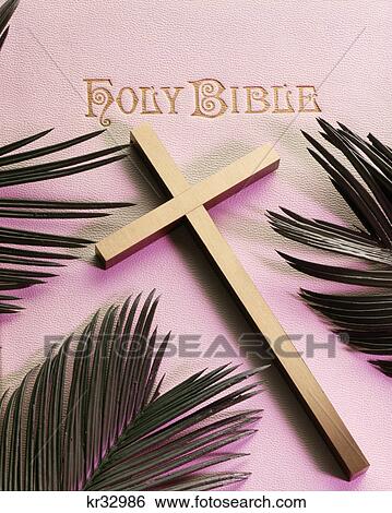 Stock Photograph - holy bible gold cross palm fronds. Fotosearch
