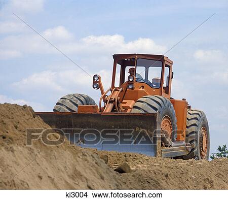 man operating a bull dozer moving earth View Large Photo Image Picture - man operating a bull dozer moving earth. Fotosearch